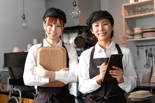 istock Young Asian women smiling and happily working at a restaurant 1696163397