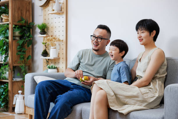 Young Asian families watching TV at home