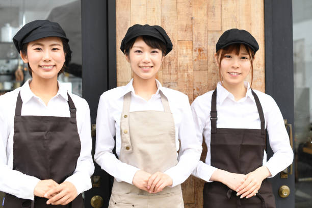 istock Several young Asian female employees smiling and greeting each other at a restaurant. 1696207929