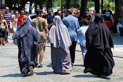 Istanbul, Turkey - July 05, 2018: Unknown women in hijab clothes on one of the central streets of Istanbul.
