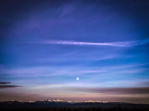 Moon setting over Bozeman Montana at sunrise