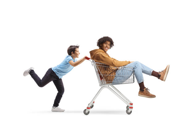istock Boy pushing a shopping cart with an african american guy inside 1696241955