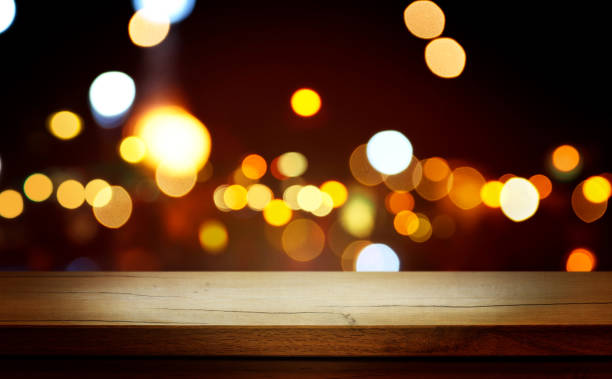 istock Christmas Bokeh Background - rustic wooden table and Magic golden blurred holidays lights - Backdrop for product presentation 1696255532