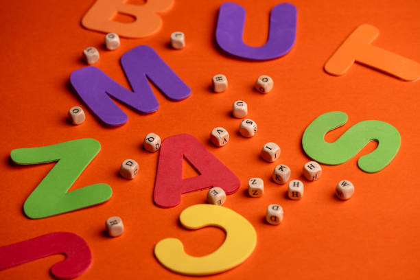 capital letters and beads on an orange background