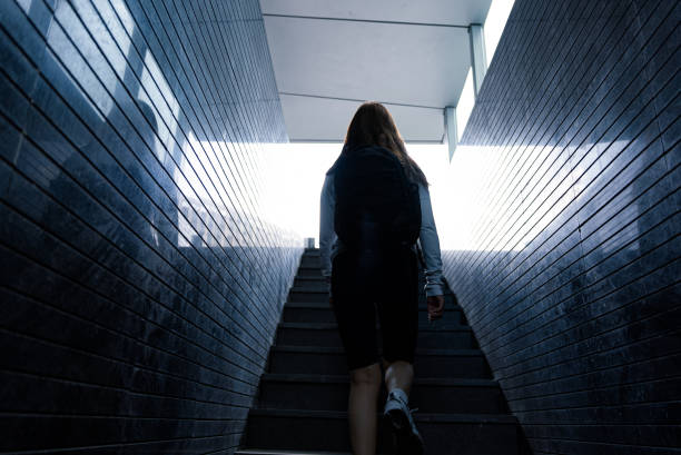 istock Women walking up in tunnel 1696325417