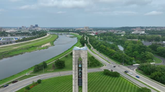 Deeds Carillon in Carillon Historical Park in Dayton, Ohio. Aerial rising shot of bell tower and downtown skyline on summer day.