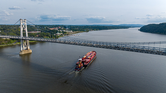 Aerial view of boat traveling down the Hudson River towards New York City.