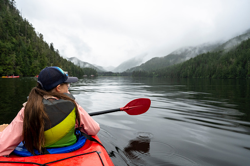 Girl sea kayaking on an Alaskan vacation. Things to do in Alaska.