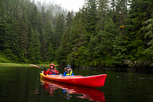 Family sea kayaking on an Alaskan vacation. Things to do in Alaska.