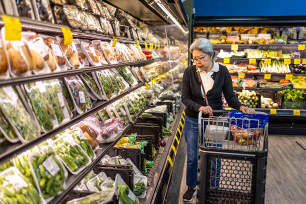 Senior Shopping at Grocery Store stock photo