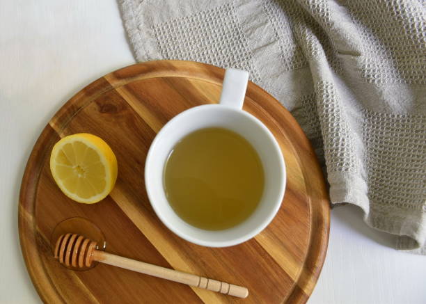 istock Tea cup, lemon and honey on wooden cutting board 1696429972