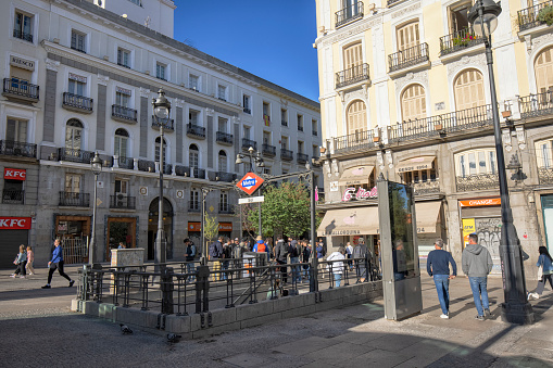 Partial view of Puerta del Sol Square in the morning, Madrid, Spain. Tourists around the entrance of Metro station.