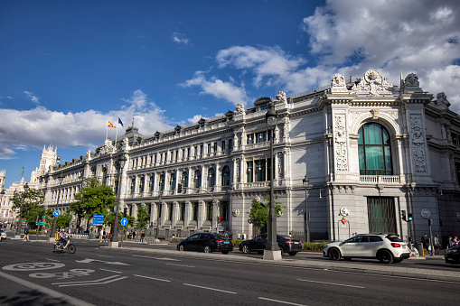 Street view of Bank of Spain building on Gran Via street on a sunny afternoon, Madrid, Spain.
