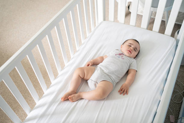 istock Baby sleeping in a safe crib 1696454498