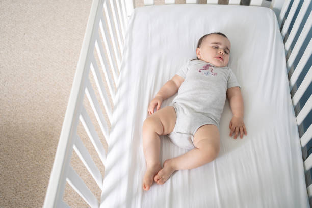 istock Baby sleeping in a safe crib 1696454499