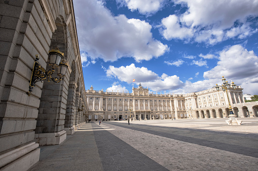 Exterior view of Royal Palace of Madrid from the Plaza de Armeria on a sunny afternoon, Madrid, Spain.