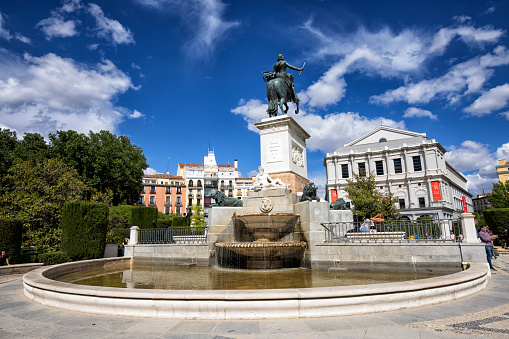 Street view of Plaza de Oriente, Madrid, Spain. Monument to Philip IV of Spain (17th century) over a fountain.