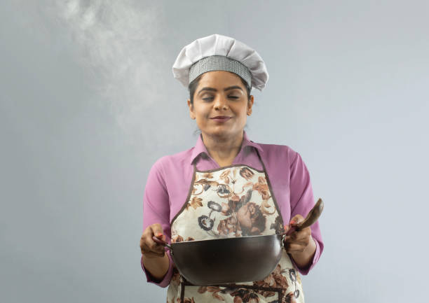 istock Chef smelling food in cooking pan on white background 1696510513
