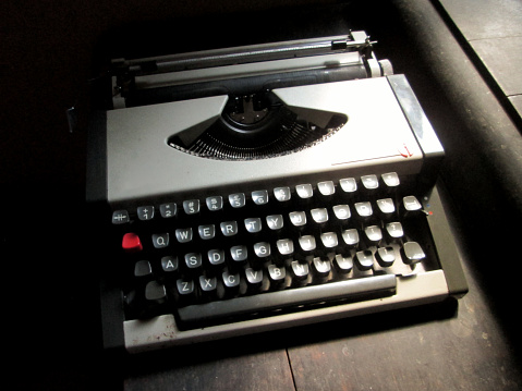 A typewriter is a mechanical or electromechanical machine for typing characters. Typically, a typewriter has an array of keys, and each one causes a different single character to be produced on paper by striking an inked ribbon selectively against the paper with a type element
