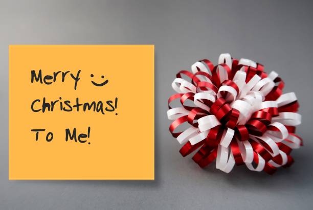 istock A red white gift bow and a yellow stick note on gray background with text written Happy Christmas to me, concept of modern day lifestyle or single people who spend Christmas New Year Holiday season alone by themselves 1696521448