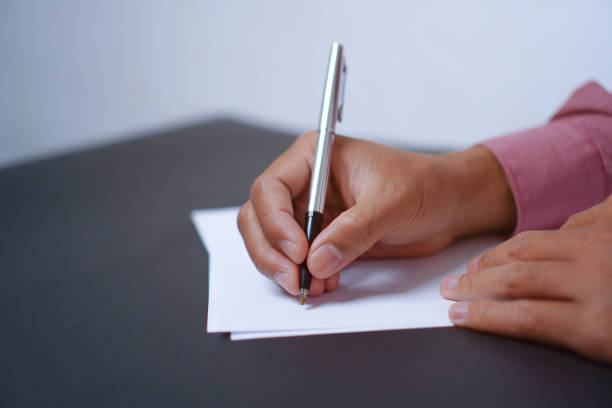 Man Holds a Pen and Ready to Write on Sheets of Paper, Writing Letter Concept