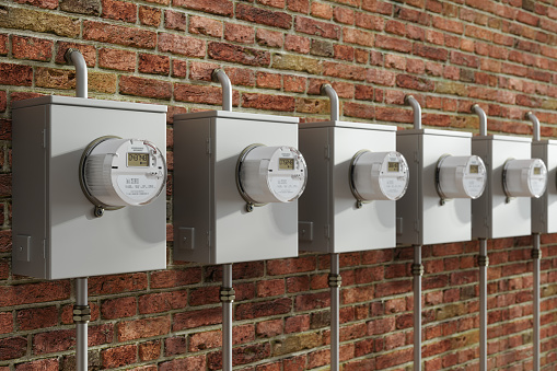 Close-up View Of Electric Meters On Brick Wall