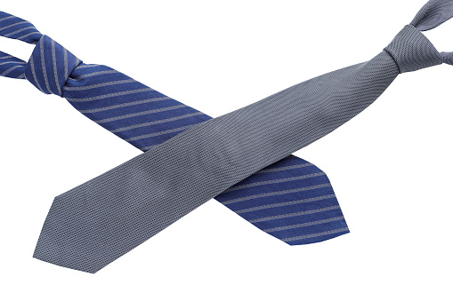 Top view of a blue striped silk tie and black neck tie on white background. Father's day concept