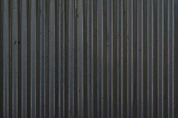 istock Black corrugated metal sheet background and texture surface 1696669006