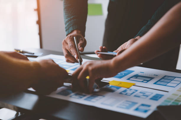 istock A group of Asian UI developers, designers, and data researchers are brainstorming their projects with laptops, smartphones, and digital tablets. Creative Digital Development Agency. 1696683765