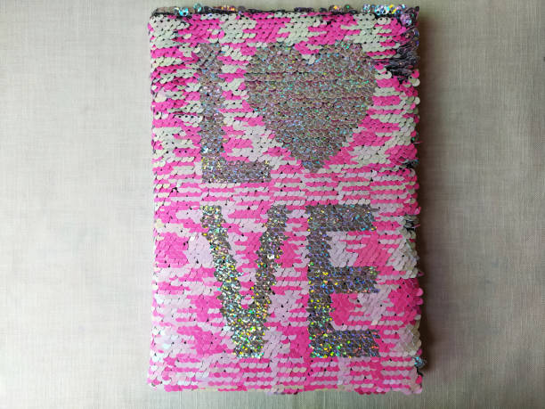 A pink book with love sign was placed on the table