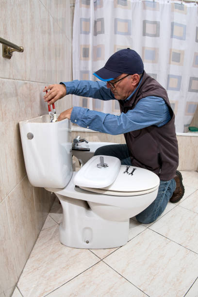 istock Plumber repairing a toilet cistern 1696692513