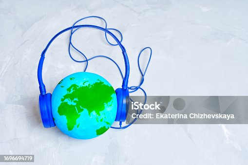Globe and Headphones Isolated on Concrete Background