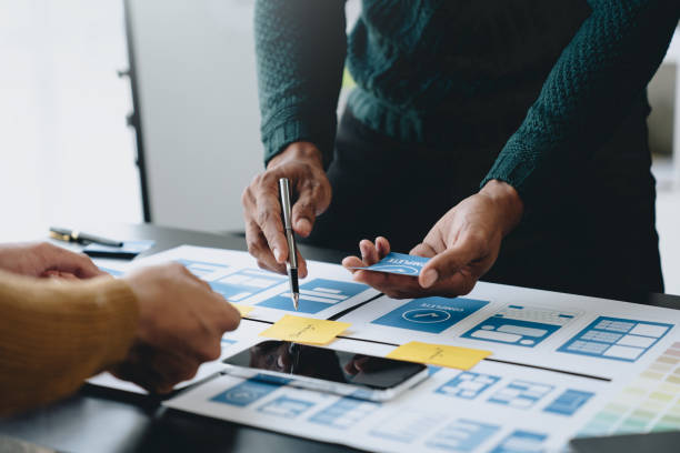 istock A group of Asian UI developers, designers, and data researchers are brainstorming their projects with laptops, smartphones, and digital tablets. Creative Digital Development Agency. 1696695267
