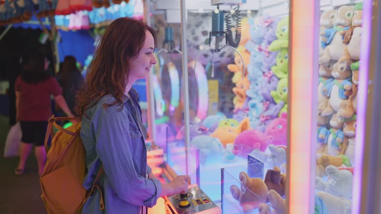 Woman playing on claw machine