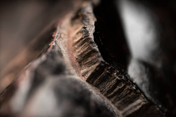 Close-up of raw hematite. Surface of iron ore. Grey reflective mineral texture.Reflective patterns on rock surface. Silver gray background, wallpaper. Extreme macrophotography. Futuristic look, aesthetic.