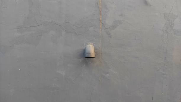 istock An exhaust pipe from a house with grey painted wall in urban area 1696729248