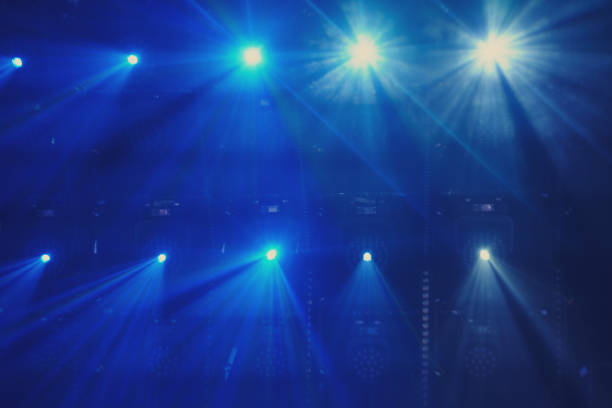 Stage lights on a blue background. The stage is illuminated by the spotlight.