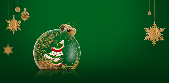 Christmas ornaments on green background, copy space.
