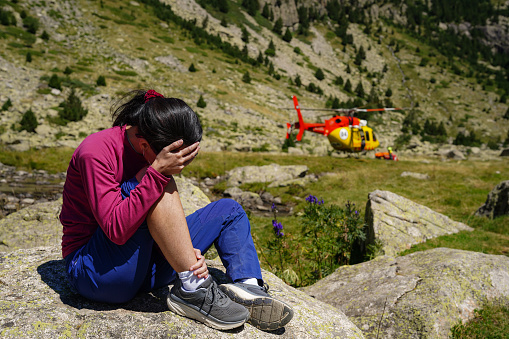 Mountain rescue helicopter in an emergency. Assistance with insurance in a woman accident.