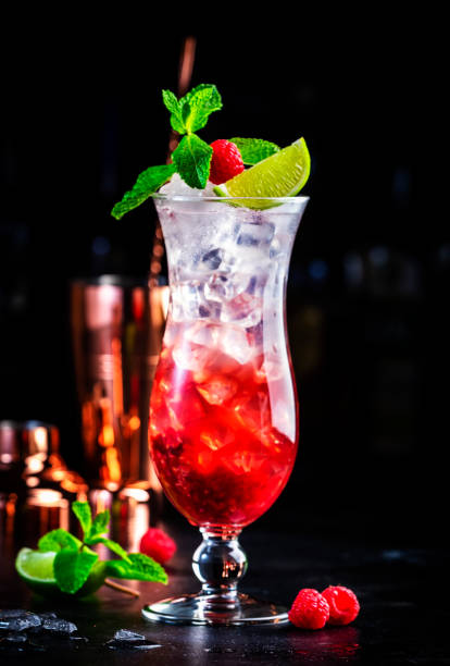 istock Raspberry lemonade non alcoholic cocktail or mocktail drink with raspberries, syrup, soda, lime, mint and ice, dark bar counter background 1696738271