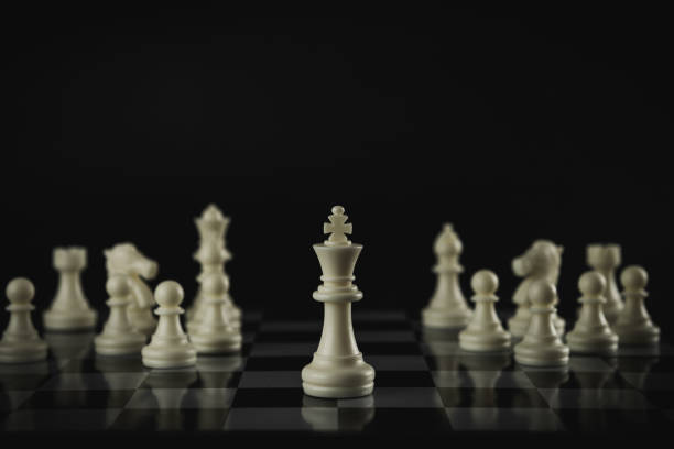 istock Pieces on chess board on black background for playing game and strategy. 1696745361