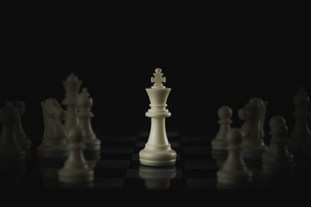 istock Pieces on chess board on black background for playing game and strategy. 1696745550