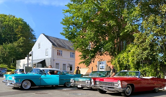 The photo was taken on September 9th 2023 in Tranebjerg, Samsø Island, Denmark. The Danish Cadillac Club is gathering, getting ready to take a road trip.