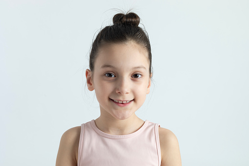 8 years old girl in front of white background.