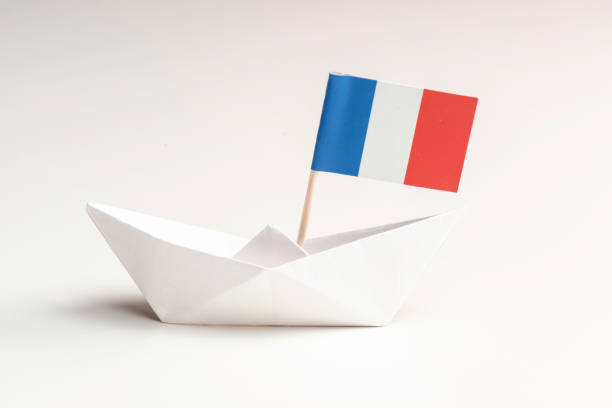 istock French Flag with Paper Boat 1696756887