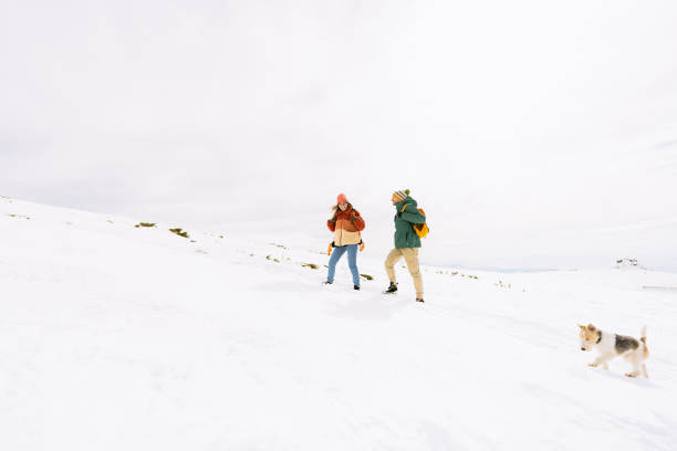 istock Smiling couple climbing the snowy mountain 1696823285