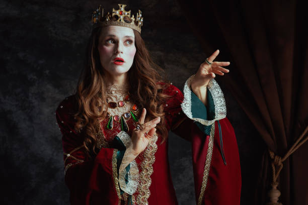 istock medieval queen in red dress with white makeup and crown 1696823627