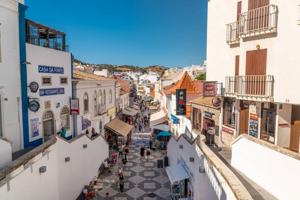 Beautiful city center of the city. Old town with white houses and narrow pedestrian streets. Albufeira, ALGARVE, Portugal - September 28 2022: Beautiful city center of the city. Old town with white houses and narrow pedestrian streets. Travel destination in South of Portugal. People on street historic-district stock pictures, royalty-free photos & images