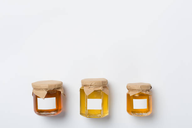 istock Jars with different honey on wooden background, top view. Mock up design 1696910272