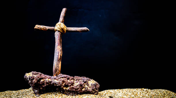 istock wooden cross on black background 1696915864